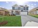 Two-story house with gray siding, white trim, and a large yard at 292 Chestnut Oak Ln, Lillington, NC 27546