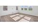 Open living area with large windows and wood-look floors at 292 Chestnut Oak Ln, Lillington, NC 27546