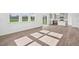 Spacious living room with kitchen view and wood-look floors at 292 Chestnut Oak Ln, Lillington, NC 27546
