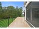 A relaxing back porch offers amazing nature views with a metal railing and screened enclosure at 1701 Legacy Ridge Ln, Wake Forest, NC 27587