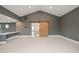 Partially-furnished basement space featuring gray walls and a decorative sliding barn door at 1701 Legacy Ridge Ln, Wake Forest, NC 27587