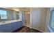 Bright bathroom featuring double sinks, wood-look flooring, and a modern glass shower at 191 Robert Howe Dr, Fuquay Varina, NC 27526