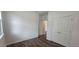 Bedroom with hardwood flooring, neutral walls, and a double-door closet at 191 Robert Howe Dr, Fuquay Varina, NC 27526