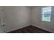 Cozy bedroom features hardwood flooring and a bright window at 191 Robert Howe Dr, Fuquay Varina, NC 27526