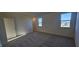 Bedroom with carpet, multiple windows, and a closet at 191 Robert Howe Dr, Fuquay Varina, NC 27526