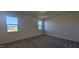 Bedroom with carpet and two windows overlooking the neighborhood at 191 Robert Howe Dr, Fuquay Varina, NC 27526
