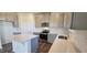 Modern kitchen with white backsplash, stainless appliances, white countertops and gray cabinets at 191 Robert Howe Dr, Fuquay Varina, NC 27526