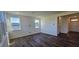 Bright living room features hardwood floors, white walls, and multiple windows at 191 Robert Howe Dr, Fuquay Varina, NC 27526