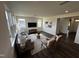 Bright living room with hardwood floors, large windows, a comfortable sofa, stylish chairs, and modern decor at 191 Robert Howe Dr, Fuquay Varina, NC 27526