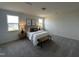 Cozy main bedroom with carpeted floors, two windows, accent wall decor, and a comfortable bed at 191 Robert Howe Dr, Fuquay Varina, NC 27526
