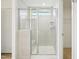 Modern bathroom featuring a glass shower with white tile and built-in shelving at 401 Winding Creek Dr, Lillington, NC 27546