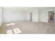 Large bedroom featuring neutral carpet, natural light, and an open doorway at 401 Winding Creek Dr, Lillington, NC 27546