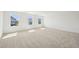 Bright, spacious bedroom with neutral carpet and abundant natural light from large windows at 401 Winding Creek Dr, Lillington, NC 27546