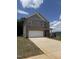 Charming brick two-story home features a large garage and well-manicured front yard at 401 Winding Creek Dr, Lillington, NC 27546