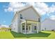 Back of home showcasing the light gray siding, white trim and covered patio at 401 Winding Creek Dr, Lillington, NC 27546