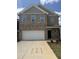 Charming brick two-story home features a large garage and well-manicured front yard at 401 Winding Creek Dr, Lillington, NC 27546