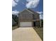 Charming brick two-story home features a large garage and well-manicured front yard at 401 Winding Creek Dr, Lillington, NC 27546