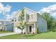Charming home with a two-car garage, lush green lawn, and welcoming front entrance at 401 Winding Creek Dr, Lillington, NC 27546