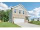 Attractive home featuring a two-car garage, well-maintained lawn, and classic architectural details at 401 Winding Creek Dr, Lillington, NC 27546