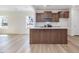 Modern kitchen features a large island with quartz countertops and stainless steel appliances at 401 Winding Creek Dr, Lillington, NC 27546