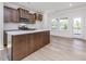 Modern kitchen features a large island with quartz countertops and stainless steel appliances at 401 Winding Creek Dr, Lillington, NC 27546