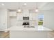 Stylish kitchen with stainless appliances, a white island, and modern pendant lighting at 401 Winding Creek Dr, Lillington, NC 27546