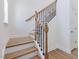 Bright staircase with hardwood steps, decorative iron spindles, and white risers at 401 Winding Creek Dr, Lillington, NC 27546