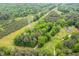 Overhead view of a private wooded property showing the home, long driveway, and a surrounding landscape of mature trees at 2723 New Sharon Church Rd, Hillsborough, NC 27278