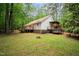 Expansive backyard featuring a wooden deck and lush greenery, ideal for outdoor relaxation at 2723 New Sharon Church Rd, Hillsborough, NC 27278