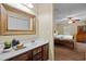 A bathroom view with wooden cabinets and white countertop, as well as a large mirror at 2723 New Sharon Church Rd, Hillsborough, NC 27278