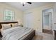 Bedroom featuring a dark wood bedframe, a ceiling fan and a window with natural light at 2723 New Sharon Church Rd, Hillsborough, NC 27278