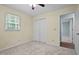 A bedroom with beige walls, carpet flooring, a ceiling fan and a closet at 2723 New Sharon Church Rd, Hillsborough, NC 27278