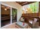 Relaxing covered outdoor deck with furniture, accessible from the interior sliding door at 2723 New Sharon Church Rd, Hillsborough, NC 27278