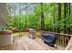 Spacious wooden deck perfect for grilling with lush green trees in the background at 2723 New Sharon Church Rd, Hillsborough, NC 27278