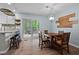 Cozy dining area with a wooden table, seating for four, and a view to the back deck at 2723 New Sharon Church Rd, Hillsborough, NC 27278