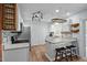 Modern kitchen with stainless steel appliances, mosaic backsplash, and bar stool seating at 2723 New Sharon Church Rd, Hillsborough, NC 27278