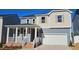 Two-story home with gray siding, red door, and a white garage door at 1341 Underbrush Dr, Durham, NC 27703