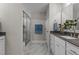 Bathroom featuring a glass-enclosed shower, grey countertop, white cabinets and tiled floor at 30 Diamond Creek Dr, Zebulon, NC 27597