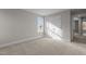 Carpeted bedroom with neutral walls and trim with natural light and closet at 30 Diamond Creek Dr, Zebulon, NC 27597