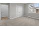 Bedroom featuring neutral walls, plush carpet, a window, and a double-door closet at 30 Diamond Creek Dr, Zebulon, NC 27597
