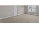 Bedroom featuring neutral walls, carpet, a window, and a door at 30 Diamond Creek Dr, Zebulon, NC 27597