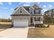 Charming two-story home with a well-manicured lawn, a two-car garage, and a classic architectural design at 30 Diamond Creek Dr, Zebulon, NC 27597