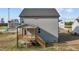View of home with vinyl siding and wooden deck with steps and gray roof at 30 Diamond Creek Dr, Zebulon, NC 27597