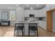 Bright kitchen with a granite island, stainless steel appliances, and white cabinetry at 30 Diamond Creek Dr, Zebulon, NC 27597