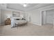 The main bedroom features neutral walls, plush carpet, and a seating bench at the end of the bed at 30 Diamond Creek Dr, Zebulon, NC 27597
