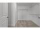 Walk-in closet featuring shelving for ample storage space and neutral carpet at 30 Diamond Creek Dr, Zebulon, NC 27597