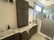 Modern bathroom features double vanity with marble countertop and tile surround shower at 4905 Hidden Pasture Way, Zebulon, NC 27597