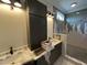 Modern bathroom featuring double vanity with marble countertop and custom tiled shower at 4905 Hidden Pasture Way, Zebulon, NC 27597