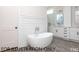 Elegant bathroom featuring stand alone tub, tile floors, and a double vanity at 4905 Hidden Pasture Way, Zebulon, NC 27597