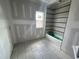 Bathroom under construction showing tile floors, a bathtub, and one window for natural light at 4905 Hidden Pasture Way, Zebulon, NC 27597